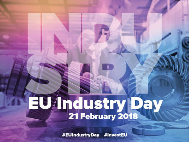 Grafika z napisem "INDUSTRY EU Industry Day 21 February 2018". Kluczowe obiekty: koła zębate, ludzie w tle.