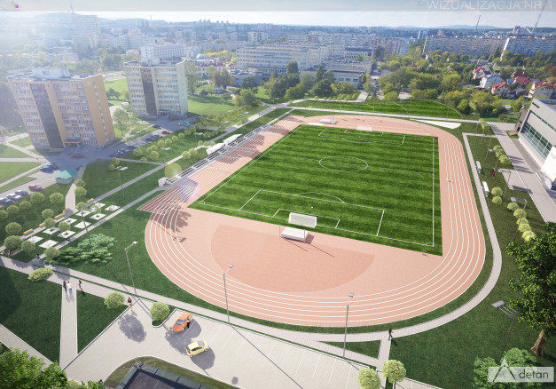 Wizualizacja obiektu sportowego z bieżnią, boiskiem i trybunami. W tle budynki mieszkalne i miejska panorama.